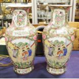 A pair of Oriental famille rose vases, panels depi