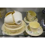 A Belleek pat tea set comprising 7 cups, 8 saucers