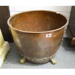 A large copper and brass mounted log basket, on paw feet, height 41cm