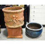 A terracotta circular planter with cherub moulded frieze 50cm diameter , a terracotta pedestal and