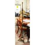A brass floor standing lamp, reeded three part column on a circular base with three feet 149cm high.
