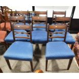 A set of eight chairs upholstered in a blue patterned fabric, 86cm high