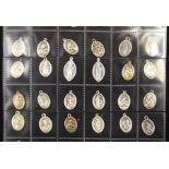 A large quantity of Catholic medallions, cased in album (500+)