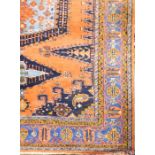 A large Persian pink, blue and green ground fringed and bordered rug, central medallion within multi