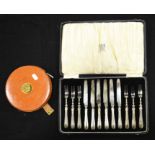 Six silver handled dessert knives and forks, cased, together with a rabone leather cased tape measur