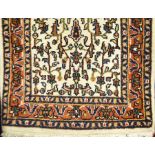A Persian wool carpet, ivory ground, 73cm x 137cm