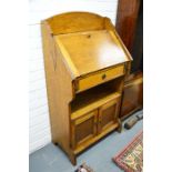 An oak fall front bureau, fitted shelf above two cupboard doors, Height 110cm