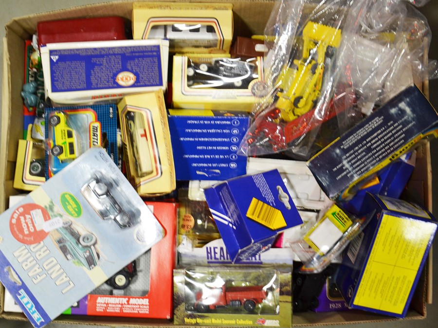 A large group of various die cast model cars in or