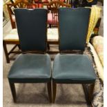 A pair of French Art Deco salon chairs, green fabric upholstery on chamfered Ruhlmann style sabre le
