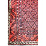 A red and black geometric borders and foliate central panel