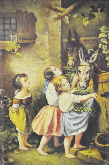 A framed picture of children with donkeys and a fr