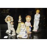 A group of five Royal Doulton and one Shelly figur
