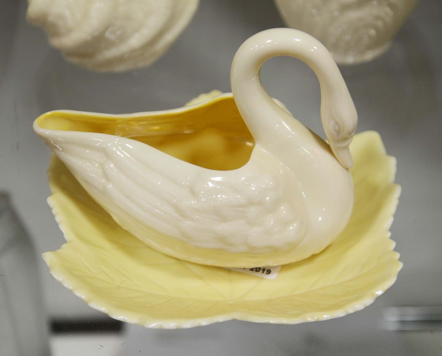 A Belleek swan neck milk jug and leaf dish, green