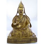 A gilded bronze figure of a seated Tibetan Buddhist Monk, H.37cm