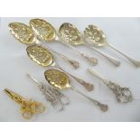 A set of five silver plated berry spoons and fork with three pairs of berry scissors, one pair