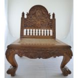 An Islamic Malay carved wooden low circumcision chair for in the form of a Javanese throne chair,