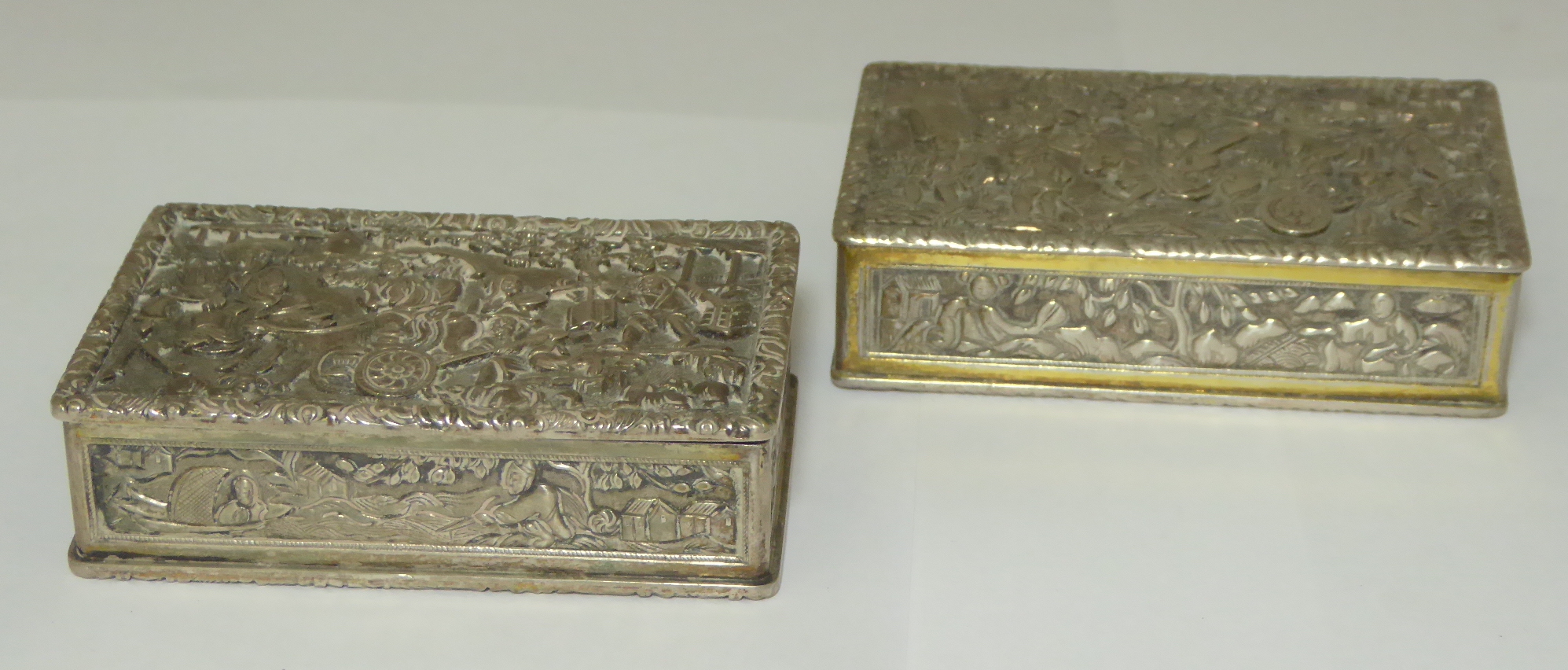 A near pair of Continental silver pill boxes depicting Chinese figural scenes, gilt interior,