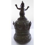 An Eastern cast bronze bell with handle in the form of a mythical beast, probably Indonesian or