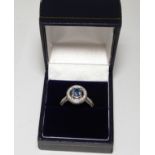 A platinum engagement ring mounted with a round cut sapphire (approx 1.26cts) and diamonds.