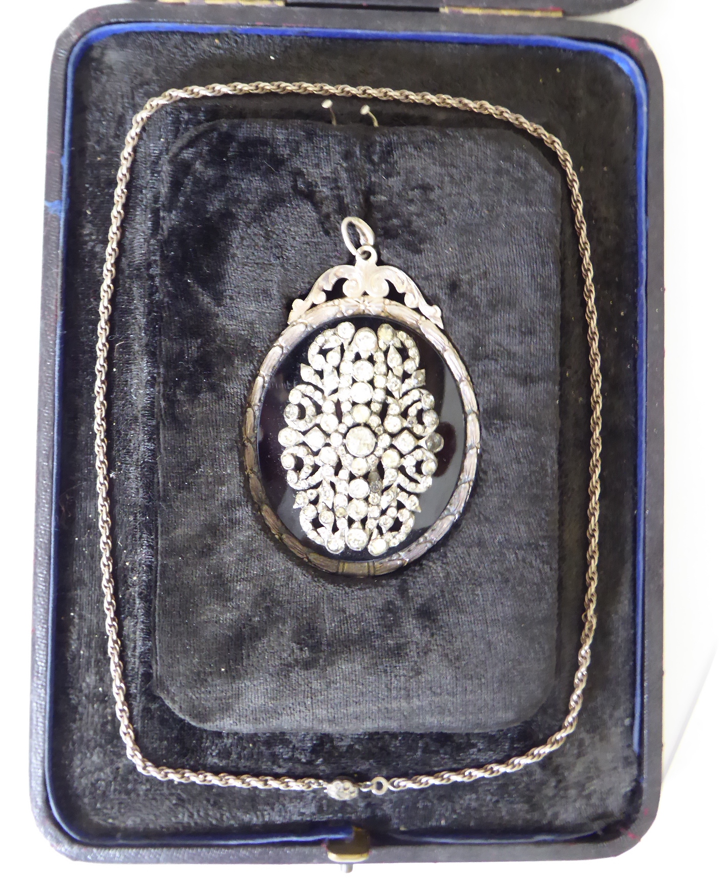 A silver backed pendant on silver chain, mounted with semi precious stones,