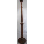 An early 20th century carved standing lamp
