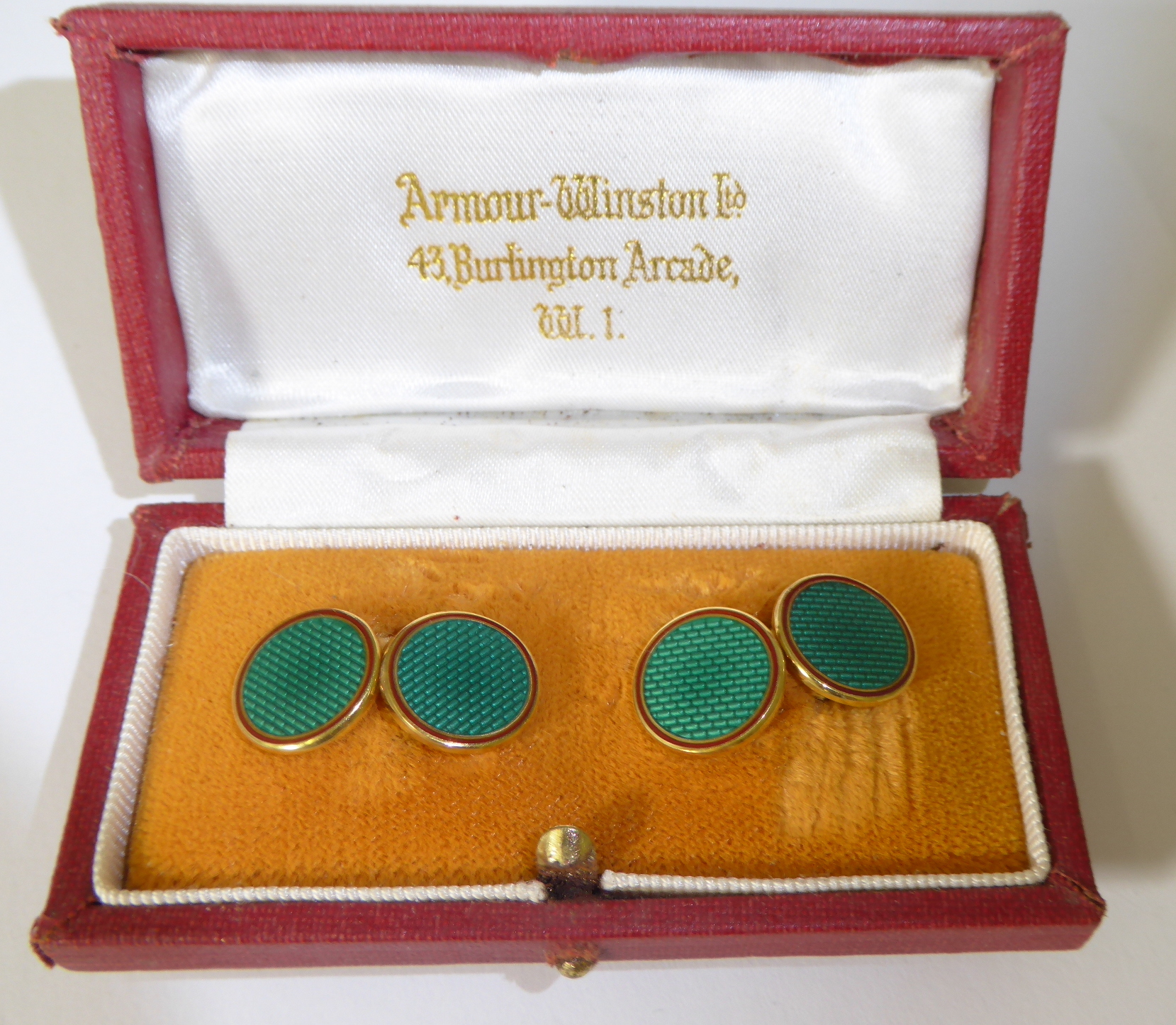 A pair of gents 9ct yellow gold green enameled cufflinks with red outer band,