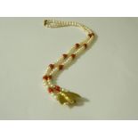 9ct gold bee pendant mounted on a pearl and coral necklace,