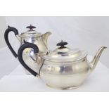 A silver teapot with matching water pot, hallmarked Sheffield 1934, maker George Howson, approx