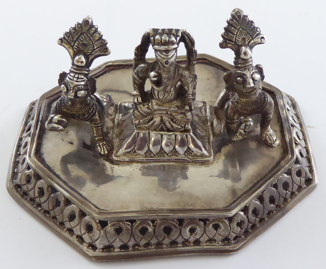 An Indian silver Hindu shrine group consisting of two crawling baby Krishna and the elephant head