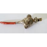 A childs silver rattle with whistle, coral handle, hallmarked