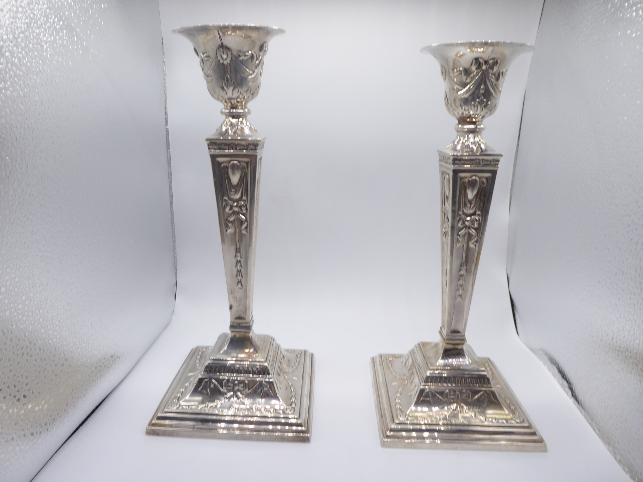 A pair of Neo Classical silver candlesticks, hallmarked Birmingham 1929, maker Burtons & Waters, H.