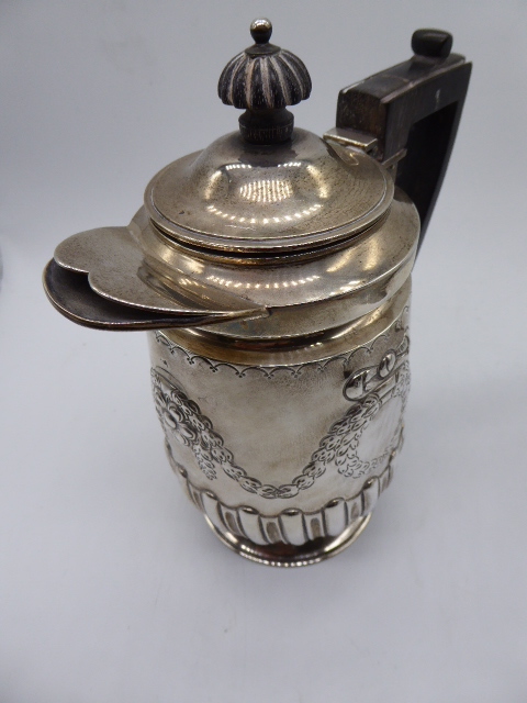 Victorian silver waterjug, repousse embossed central decor, hallmarked London 1898, maker Hawksworth