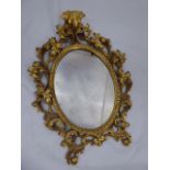 An oval gilt wood wall mirror, H.66cm