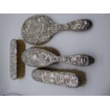 A silver four piece dressing set, hallmarked Sheffield,