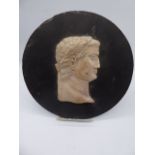 A marble carved portrait of a Roman, mounted on a slate plaque bearing inscription to verso.
