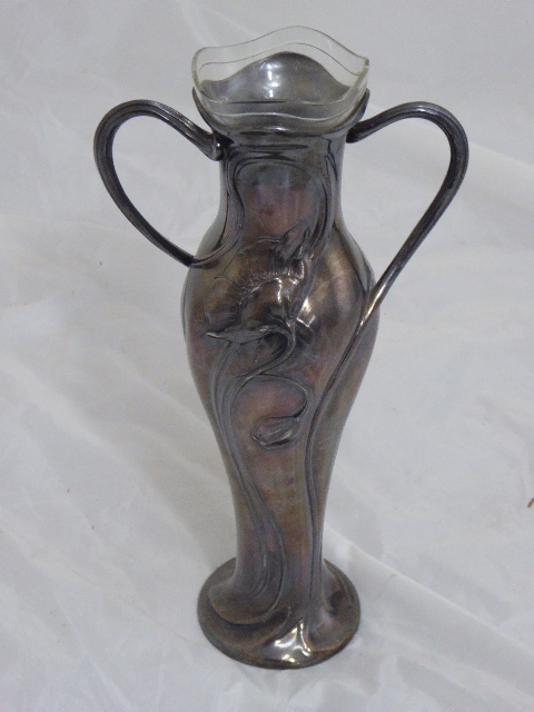 A silver plated WMF twin handled vase with floral central decor, glass liner, signed H.Decugis