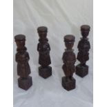 Four oak carved Continental candle holders in the form of figures playing instruments, H.52cm