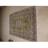 A large Persian green ground rug, 240cm x 350cm