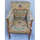 An armchair with Liberty's yellow ground upholstery and marquetry inlay