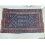 A Persian rug having central medallion on a navy ground, 80cm x 142cm