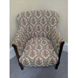 A floral upholstered mahogany armchair with marquetry inlay