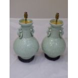 Pair of Chinese celadon glazed lamp bases, raised on hardwood bases, H.42cm