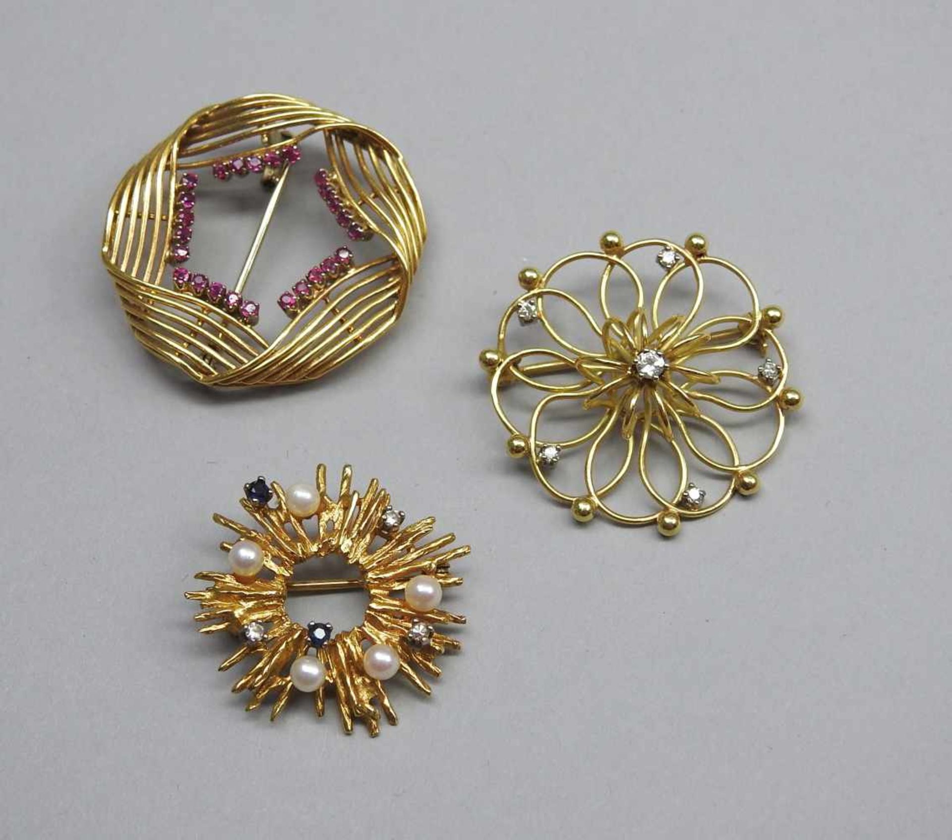 Drei goldene Broschen14 K. Gelbgold mit kleinem Diamant-, Perl- und Rubinbesatz. Deutschland,