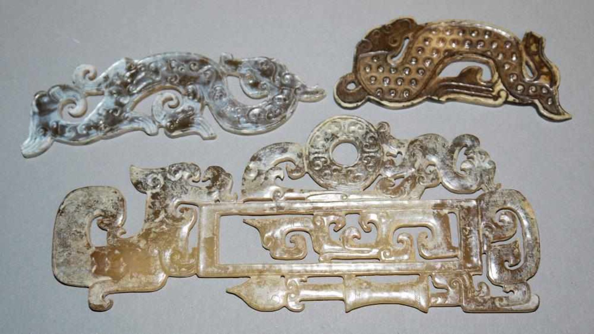 Drei chinesische Jade-Plaketten im archaischen Stil Drei durchbrochen geschnittene Jadestücke in