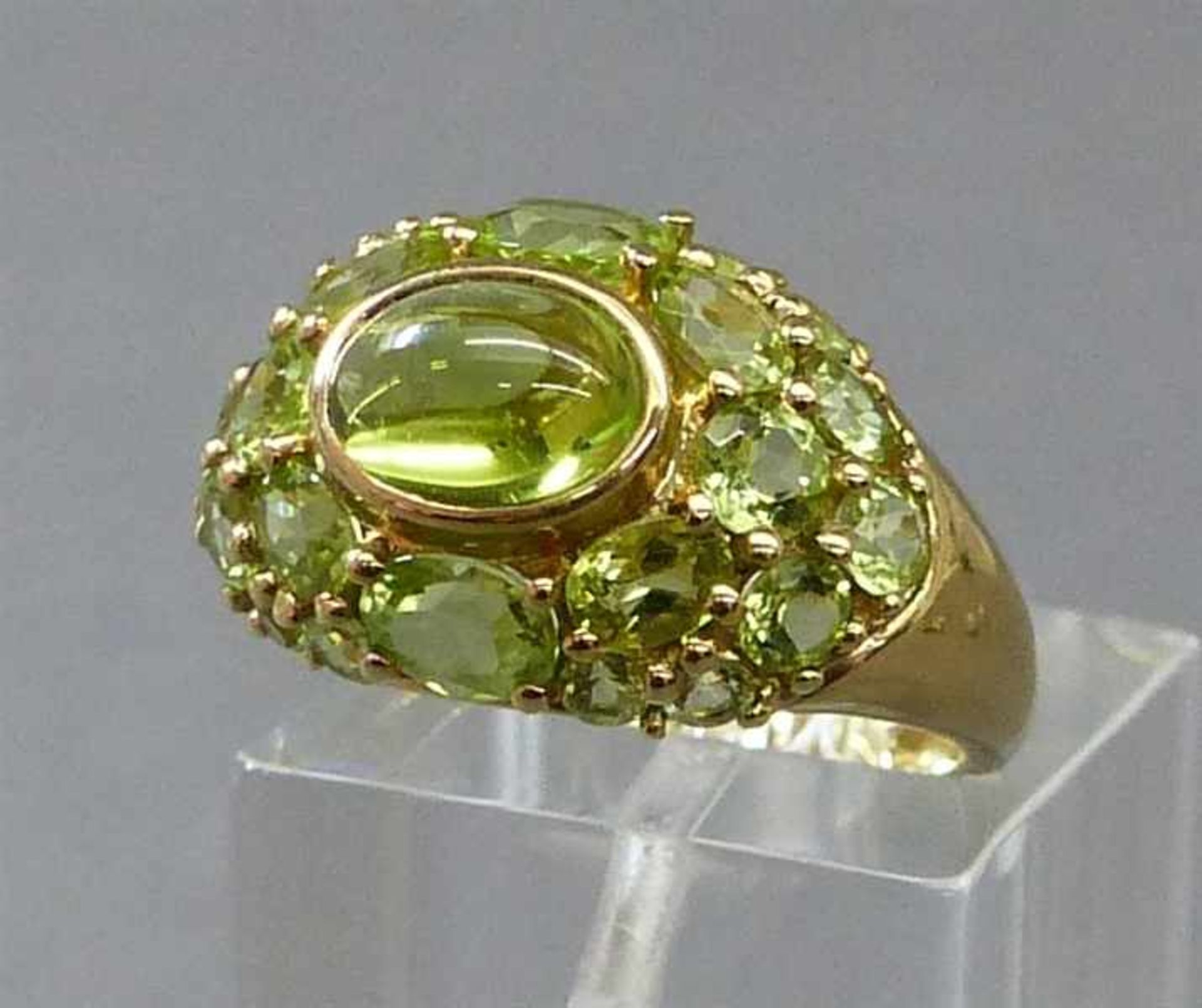 Damenring8 kt. Gelbgold, mittig 1 Peridotcabochon, geschliffene Peridots als Besatz, ca 4g, RM 54,