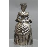 Tischglockestehende Frau mit breitem Kleid, Silber, 20. Jh., h 10 cm, 116 g schwer,