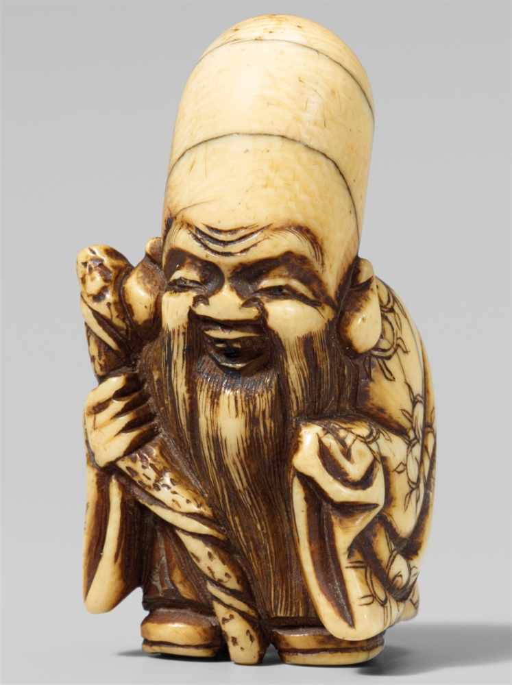 An ivory netsuke of a laughing Fukurokuju. Early 19th centuryStanding and holding a gnarled staff,
