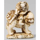 An ivory netsuke of Shôki on a shishi, by Tomochika. 19th centuryThe fierce looking demon queller