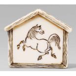 An ivory netsuke of a votive tablet (ema), by Yoshinori. 19th centuryDepicting a galloping horse,