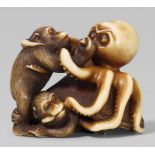 A Edo school ivory netsuke of an octopus fighting two monkeys, by Ikkôsai. Mid-19th centurySeated on